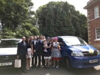 Family standing in front of Pams 2 mini bussesin Scunthorpe